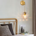 Copper wall lamp with suspended grain glass ball